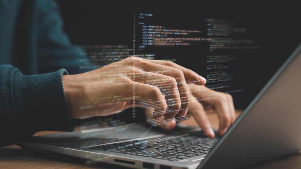 image of developer typing schema code for a website on laptop
